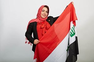 Dr. Zainab displaying the Iraq flag