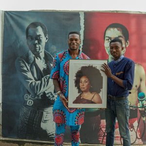 Dynast at the Kalakuta holding a picture of Sandra Izsadore, The mother of afrobeat