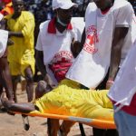 Red cross carry a man that collapsed after a pot swimming competition at the Argungu cultural fishing festival in Argungu, in Kebbi, northern Nigeria, Friday, Feb. 13, 2026. Sunday Alamba - AP