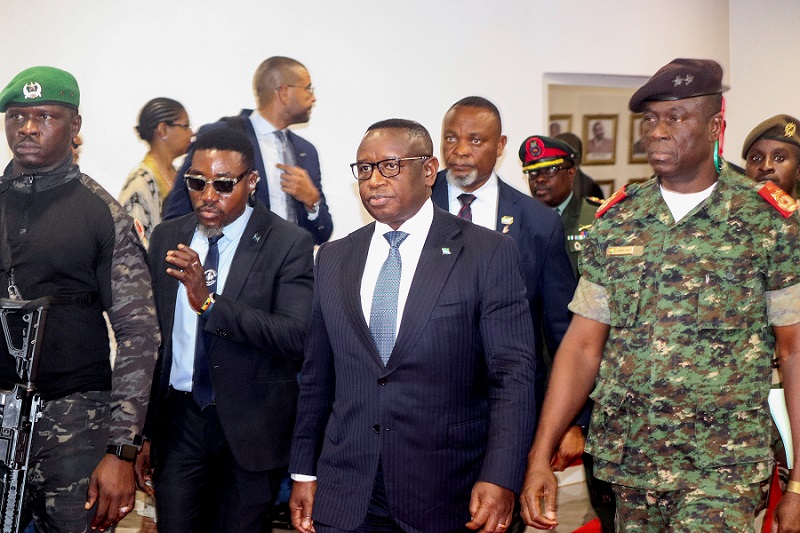 Sierra Leone's President Julius Maada Bio, who chairs ECOWAS, walks with Guinea-Bissau's transitional president Major-General Horta Inta-a during a meeting in Bissau